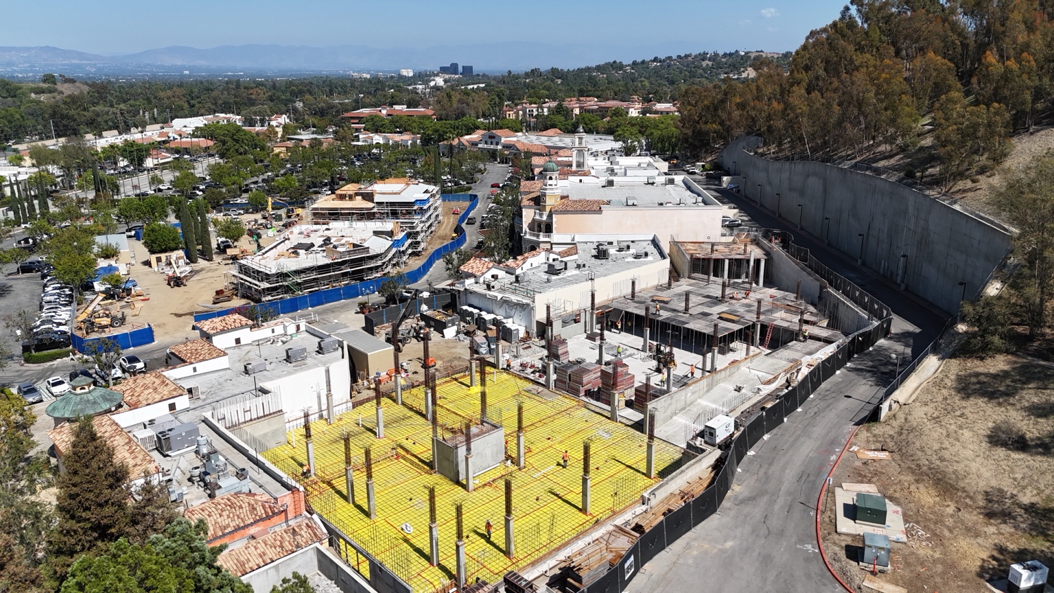 Aerial showing the broad Commons Lane construction site within the shopping center