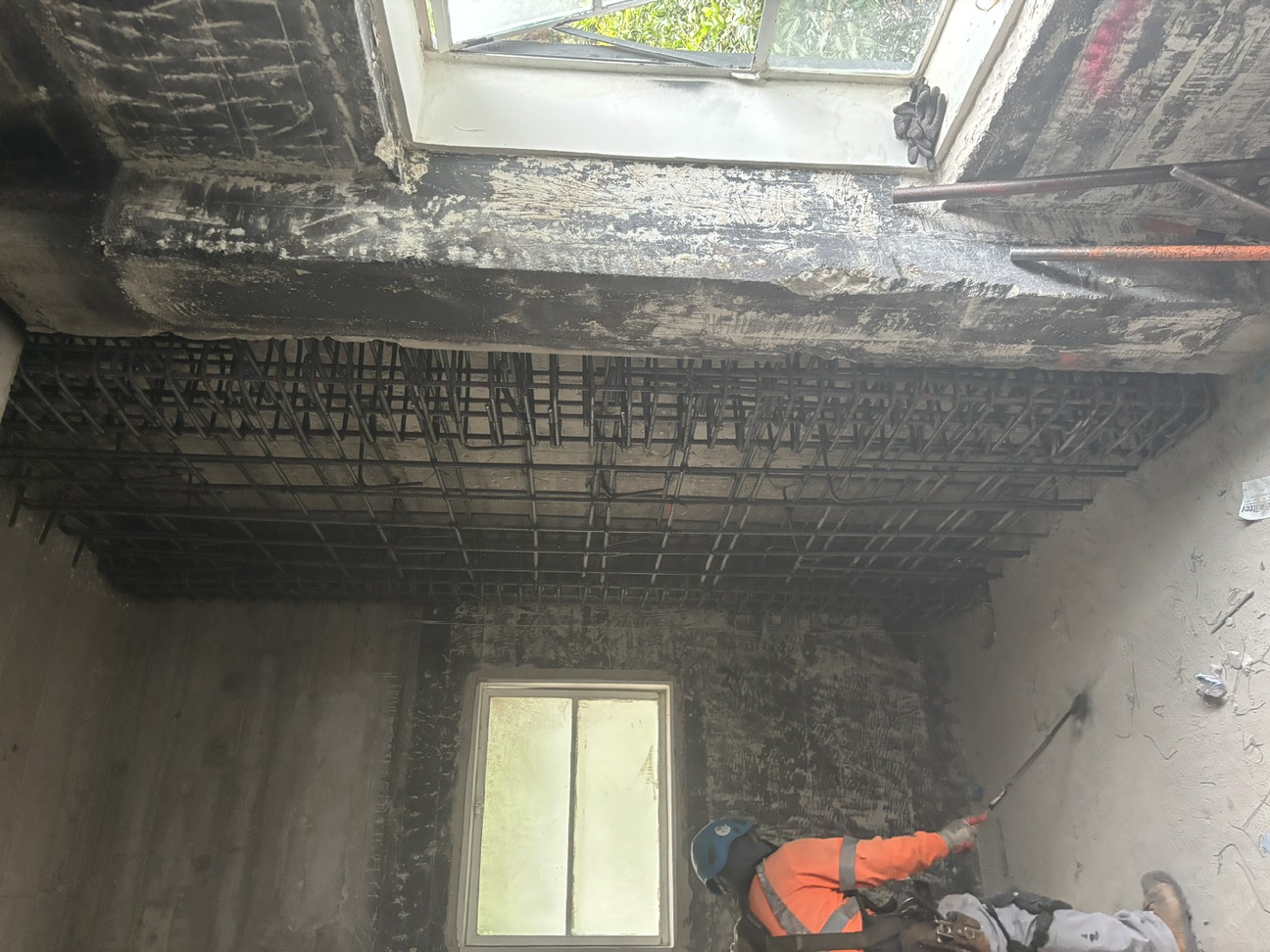 Added reinforcing cage for the thickened concrete shear wall inside the existing building